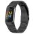 Fitbit Charge 6 med svart titanarmband i länkdesign, visad i profilvy med skärm på